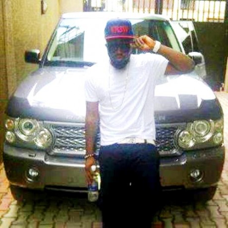 Ice Prince poses with his Range Rover SUV in 2011
