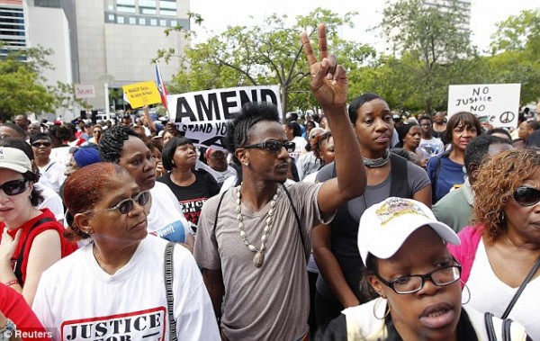 Crowds gather outside the federal courthouse in Miami as part of a nationwide response to the verdict in the George Zimmerman case