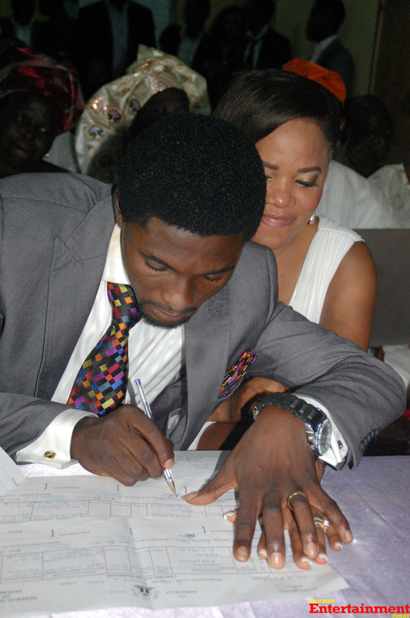 The groom signing the marriage