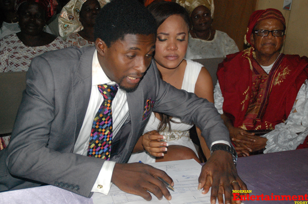 The couple signing the marriage certificate