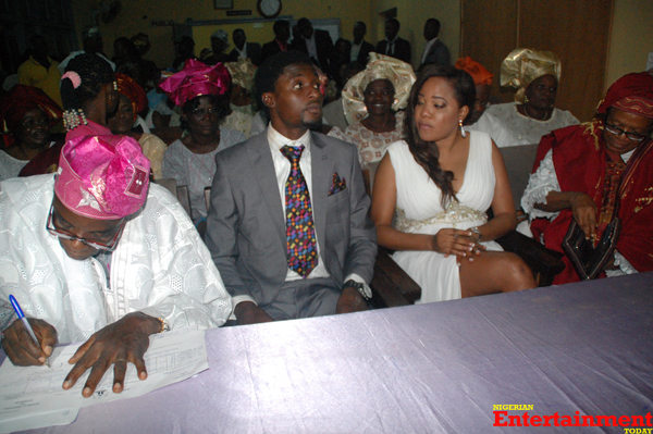 The groom's father signing the marriage certificate