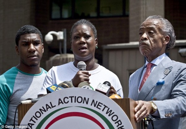 Trayvon's mother Sybrina Fulton is joined by her son, Jahvaris, left, and the Rev Al Sharpton