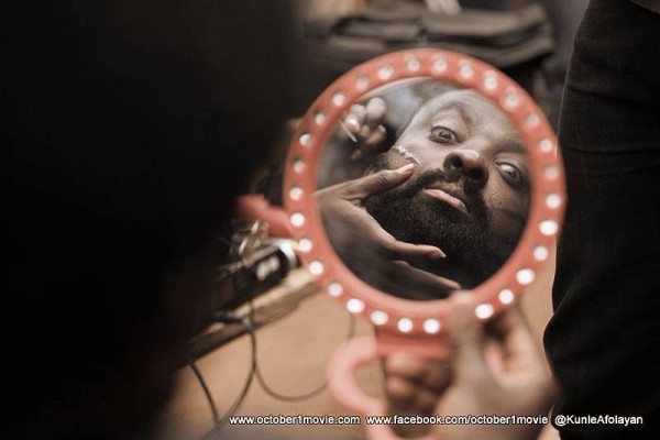 Behind-the-scene shost from 'October 1' movie Kunle Afolayan gettting his tribal marks