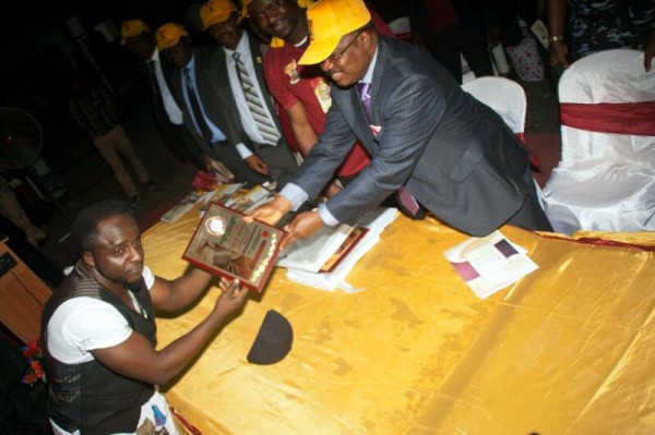 Tillaman receives his award from the Oyo State Governor, Senator Abiola Ajimobi