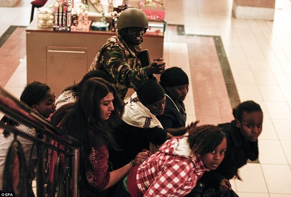 A soldier directs people up stairs inside the Westgate shopping mall after a shootout in Nairobi, Kenya