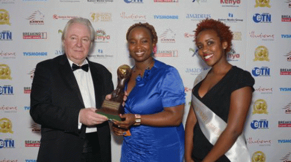 Enashipai Resort's marketing director, Elizabeth Mahiti recieves the trophy from the WTA president, Graham Cooke at the event. Photo: capitalfm