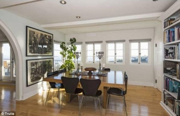 he Hollywood Hills mansion features shiny wood floorboards throughout