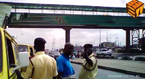 Lastma officials speaking with bus conductor at Ojota bus stop