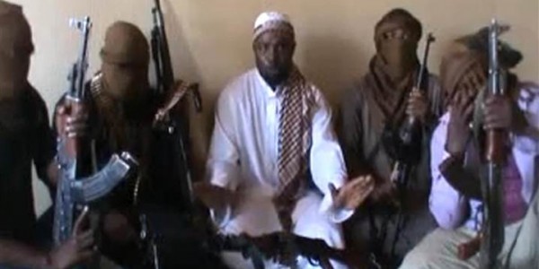 Boko Haram leader Abubakar Shekau, center, sitting flanked by militants in a still from video released on YouTube . Photo : Youtube