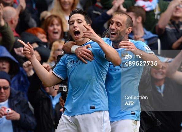 Manchester City's French midfielder Samir Nasri (L) celebrates with Manchester City's Argentian defender Pablo Zabaleta after Nasri scored his team's first goal during the English Premier League football match between Manchester City and West Ham United at the Etihad Stadium in Manchester on May 11, 2014. ANDREW YATES/AFP/Getty Images