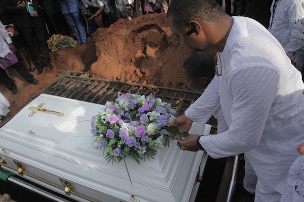 Amaka Igwe: Charles Igwe placing a flower on late Amaka Igwe's casket
