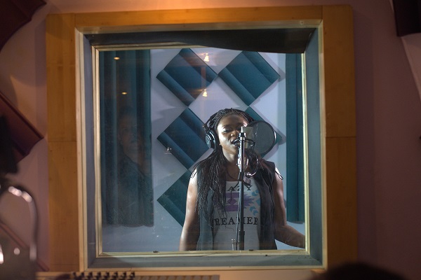 Waje in the recording booth