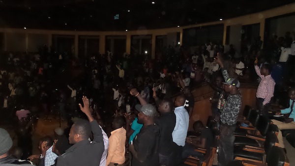 People waving kefee bye as they sing along with a performing act