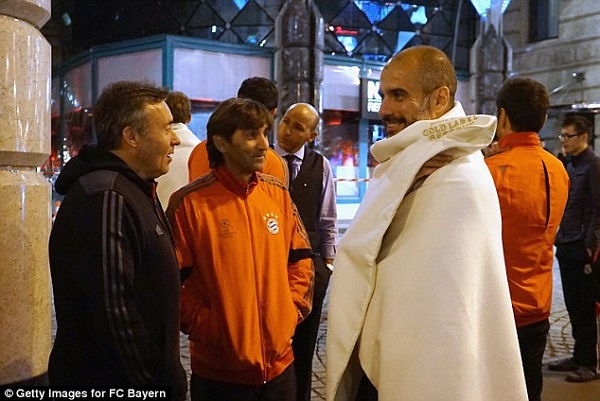 Bayern Manager Pep Guardiola was also feeling the cold as he wrapped himself in a blanket. Photo: Daily Mail