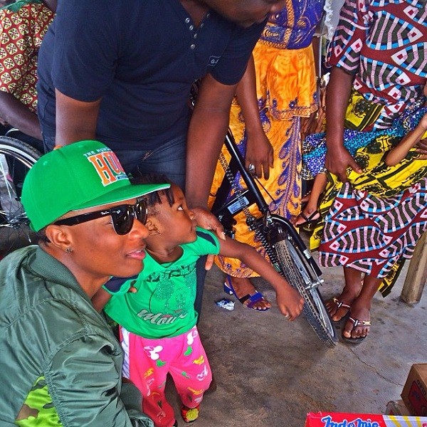 Wizkid, with a baby in Benin. Photo: Instagram