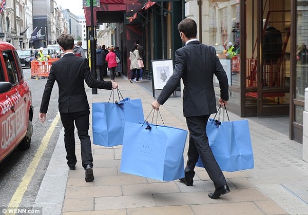 Smartly dressed assistants carried the blue shopping bags into the waiting taxi