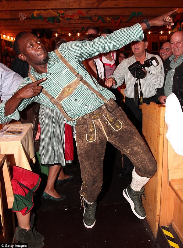 The 28-year-old sprinter pulled his trademark move as he posed for the cameras at Oktoberfest. Photo: Daily Mail