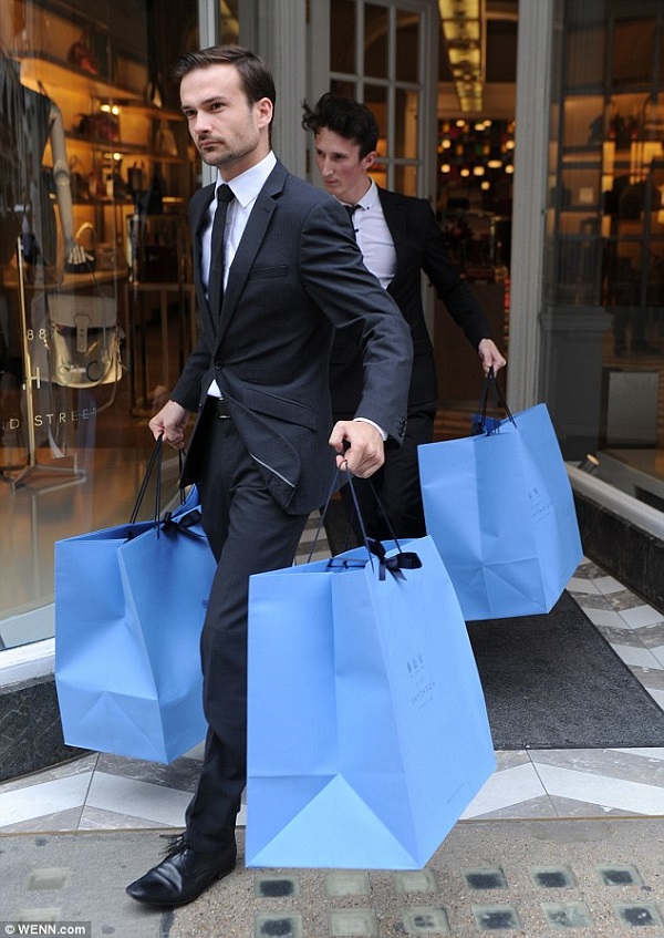 Two members of staff carried John Terry and Toni Poole's heavy shopping bags to their car following a visit to the store