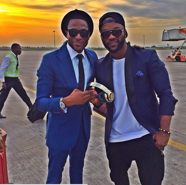 (D'banj presenting the new headphone to Iyanya at the airport)
