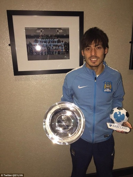 David Silva holds up his international cap award (left) and his man of the match award (right) from the convincing 3-0 win against Crystal Palace