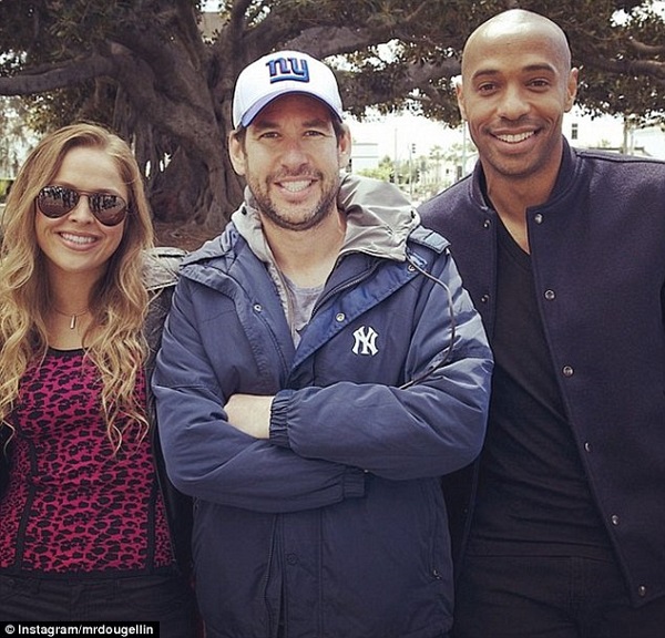 Henry (right) posed for pictures with Ellin (centre) and UFC champion Ronda Rousey (left) in April