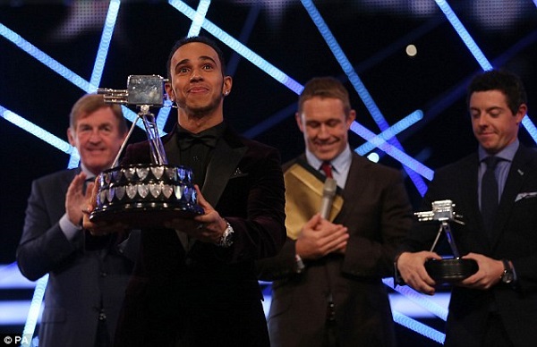 Lewis Hamilton receives the trophy as he is named 2014 BBC Sports Personality of the Year