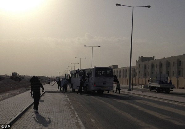Migrant workers clamber aboard a bus that carried them to the volleyball event