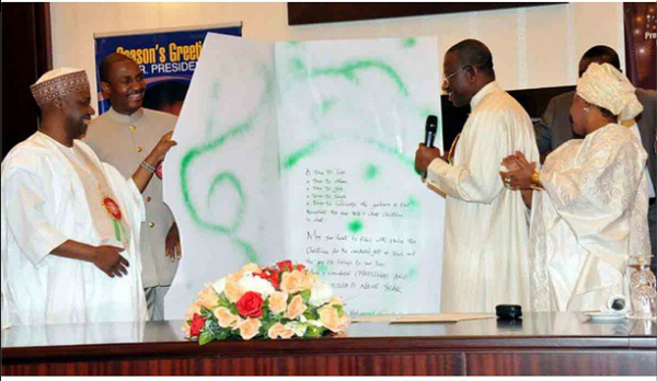 jonathan recieving the card from Namadi Sambo