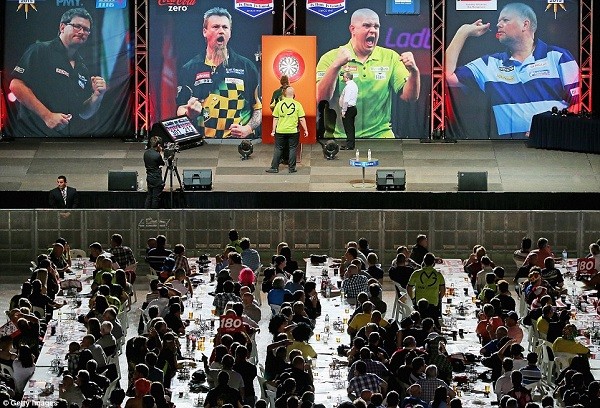 A general view of the venue with Michael van Gerwen and Simon Whitlock on stage as the crowd sit quietly