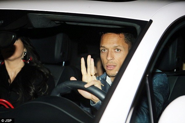 Barcelona left back Adriano gives a wave to the cameras on his way to the birthday party