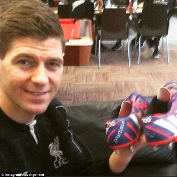 Steven Gerrard shows off the pair of boots he is set to wear on his 700th appearance for Liverpool