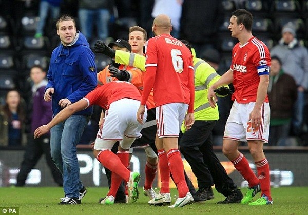 Team-mate Jamal Lascelles rushes in and rugby tackles the supporter to the ground