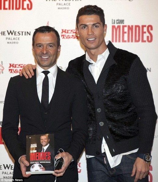 The Real Madrid forward poses with Mendes, who is holding the new book