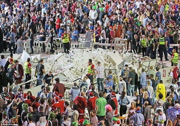 The pile of plastic chairs and tables grows as more and more are thrown by spectators