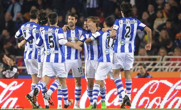Real Sociedad's players celebrate after taking an unexpectedly early lead in San Sebastian