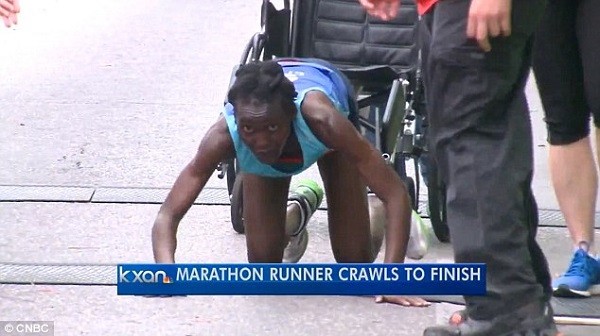 A brave Ngetich continues her race on her hand and knees as she refuses to gibe up on her race