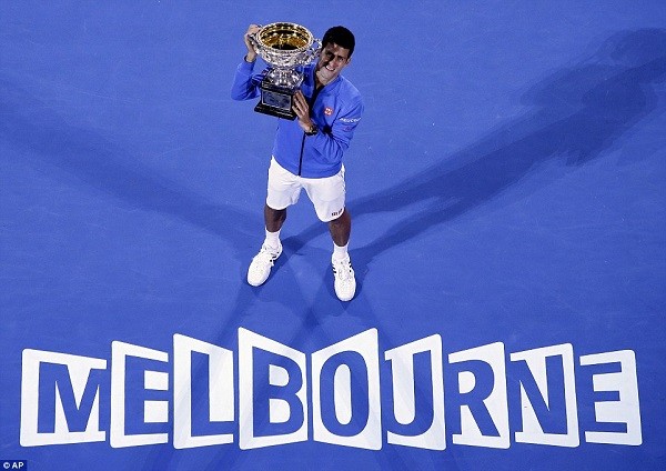 Djokovic lifts his trophy after wining a remarkable fifth title in his fifth final in Australia