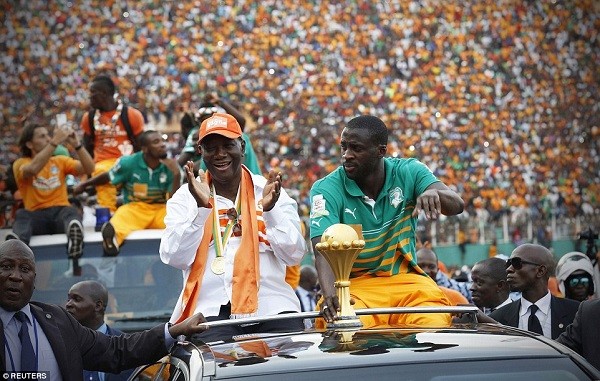 Ivory Coast president Alassane Ouattara and Ivory Coast captain Yaya Toure parade the Africa Cup of Nations trophy on Monday