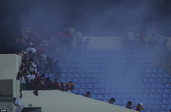Police deploy tear gas to disperse rioting fans in the stands at the Malabo Stadium