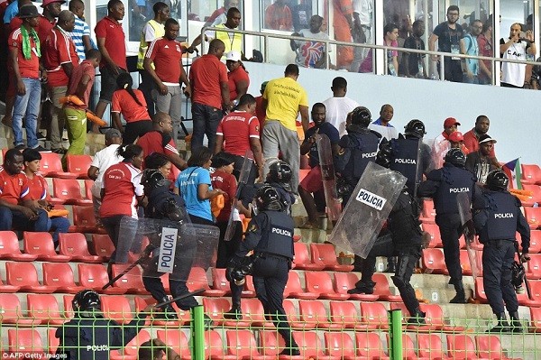 Police make their way to the top of the stands in an attempt to evacuate spectators and restore calm after missiles were thrown onto the pitch