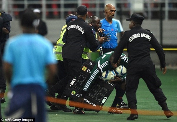 Security guards escort Seechurnaway from the field of play following the full time whistle