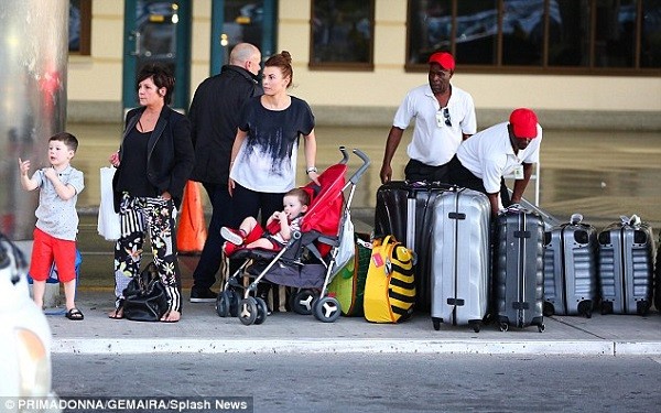 She has her mother and father in tow - but husband Wayne has remained at home due to his football commitments