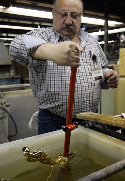 Shown above, R S Owens artisan Nunzio Giganti dips an Oscar into a electro-plating bath to coat the statuette in gold