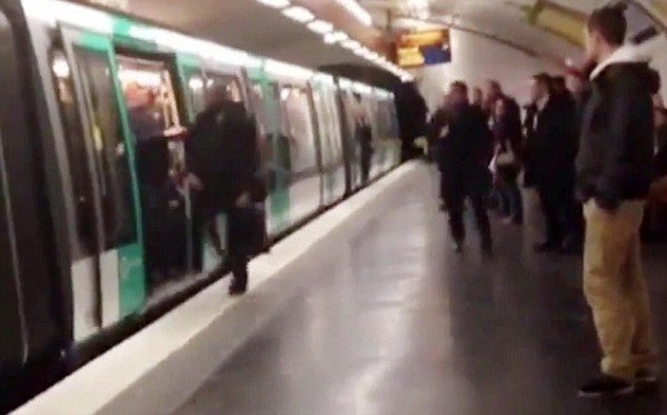 Souleymane attempts to board but is refused entry by fans travelling to the Champions League tie in Paris, as people around watches the ugly scene