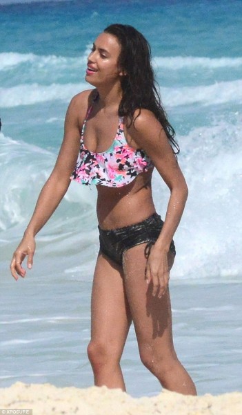 Wearing her long brunette mane in tousled curls, Irina’s striking face was perfectly made-up in muted tones appropriate for the beach location