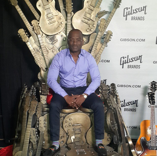 Dayo Adeneye Sitting on the guitar Legends throne Backstage at The Grammys