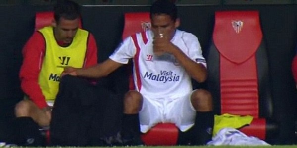 Carlos Bacca (right) holds up a jersey as team-mate Fernando Navarro has a toilet break in the dugout