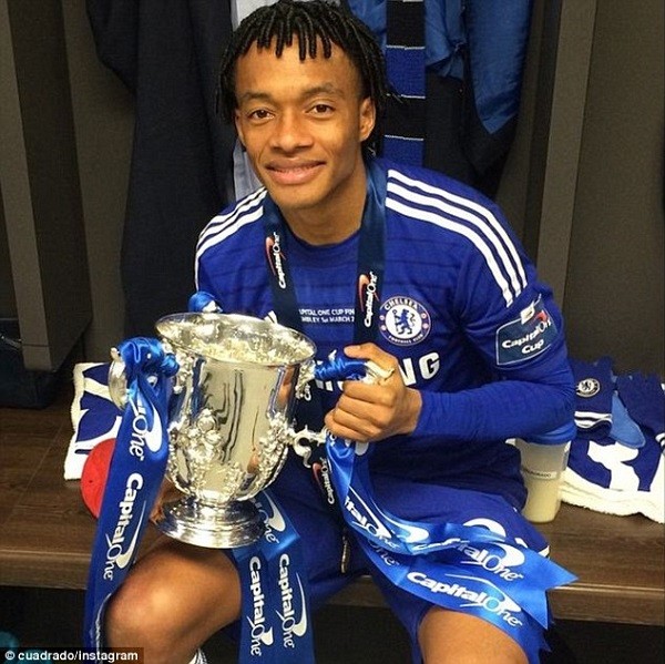Chelsea's January signing Juan Cuadrado poses for a picture with the cup in the dressing room