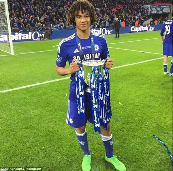 Highly-rated Chelsea youngster Nathan Ake gets his hands on the trophy on the Wembley turf after the game