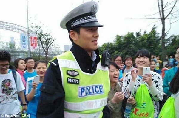 Marathon runners and supporters flock to take pictures of the handsome officer in south-western China